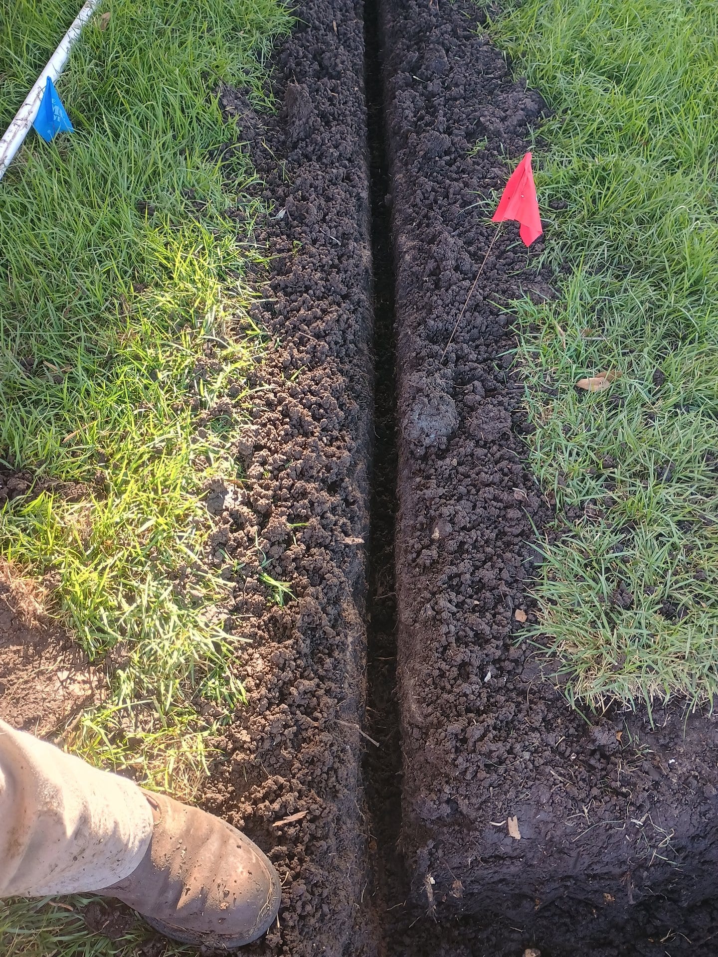 Clean irrigation trench with pipe layout for zone installation on a rural property