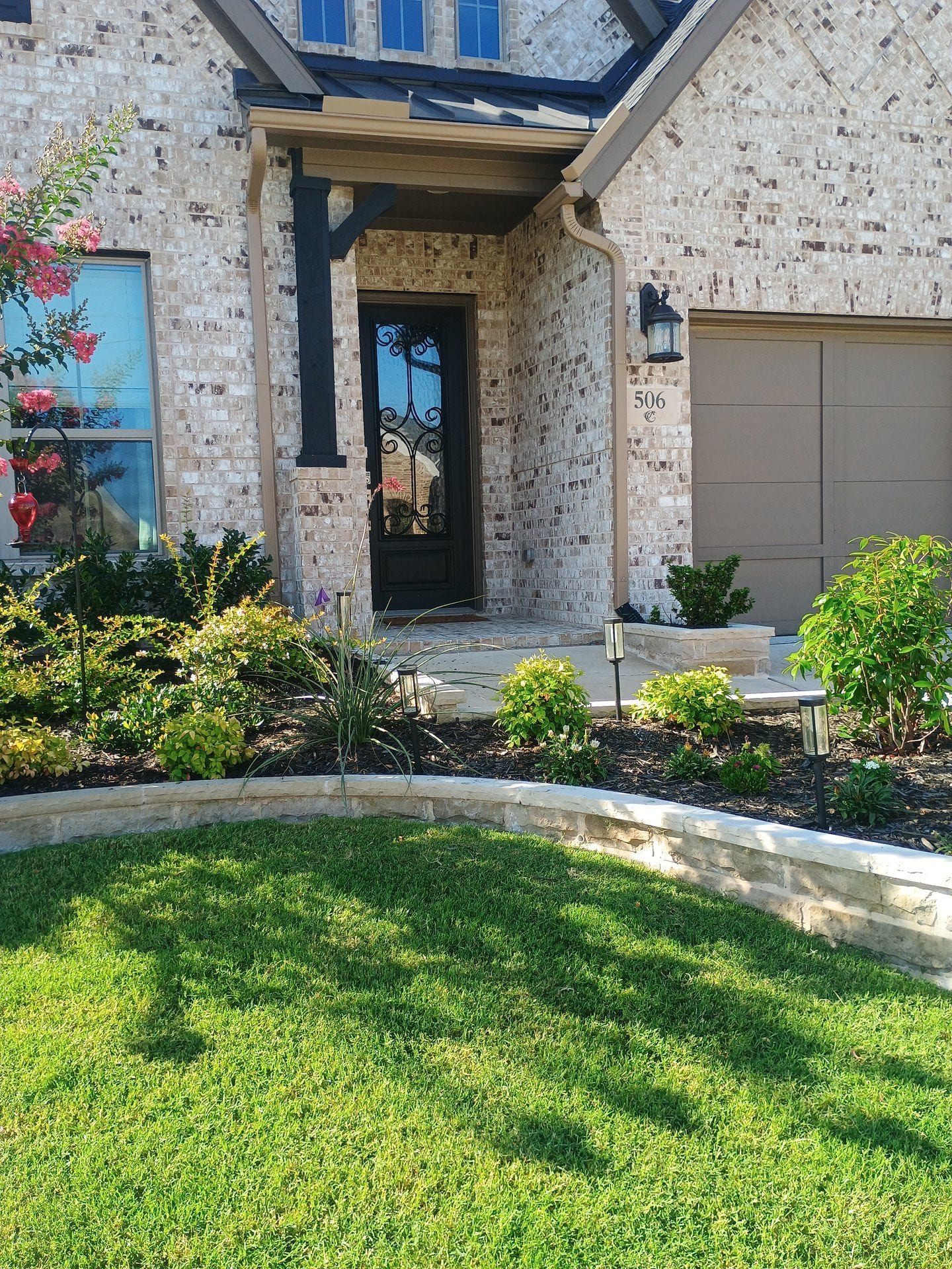 Healthy green lawn in front yard showing results of proper irrigation on clay soil