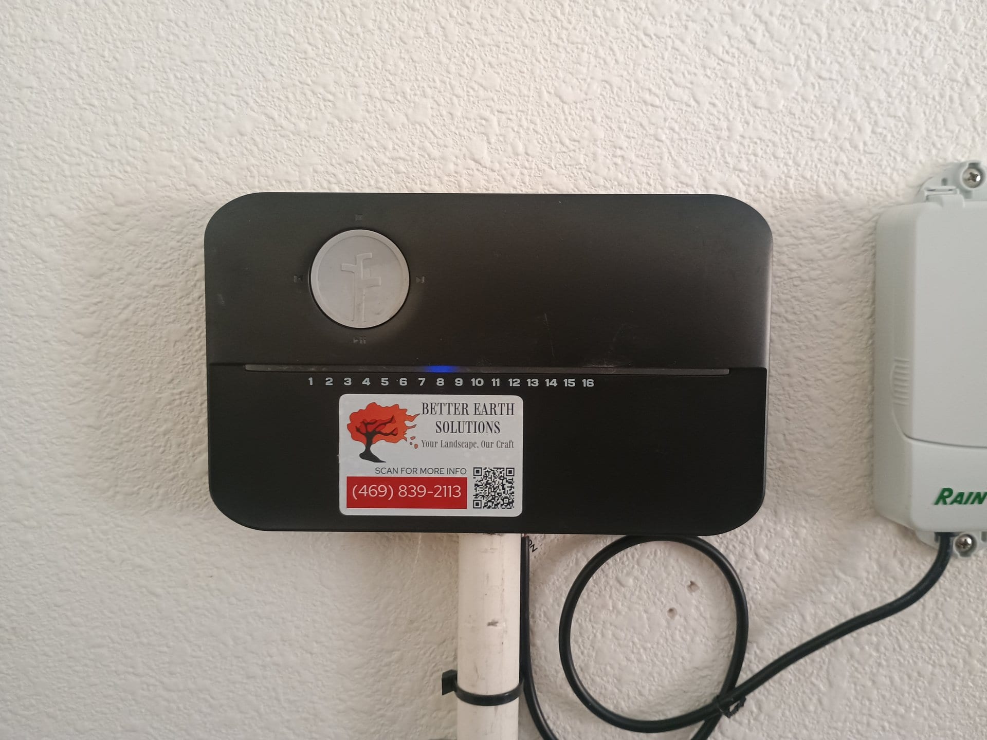 Rachio smart irrigation controller professionally installed on garage wall with Better Earth branding