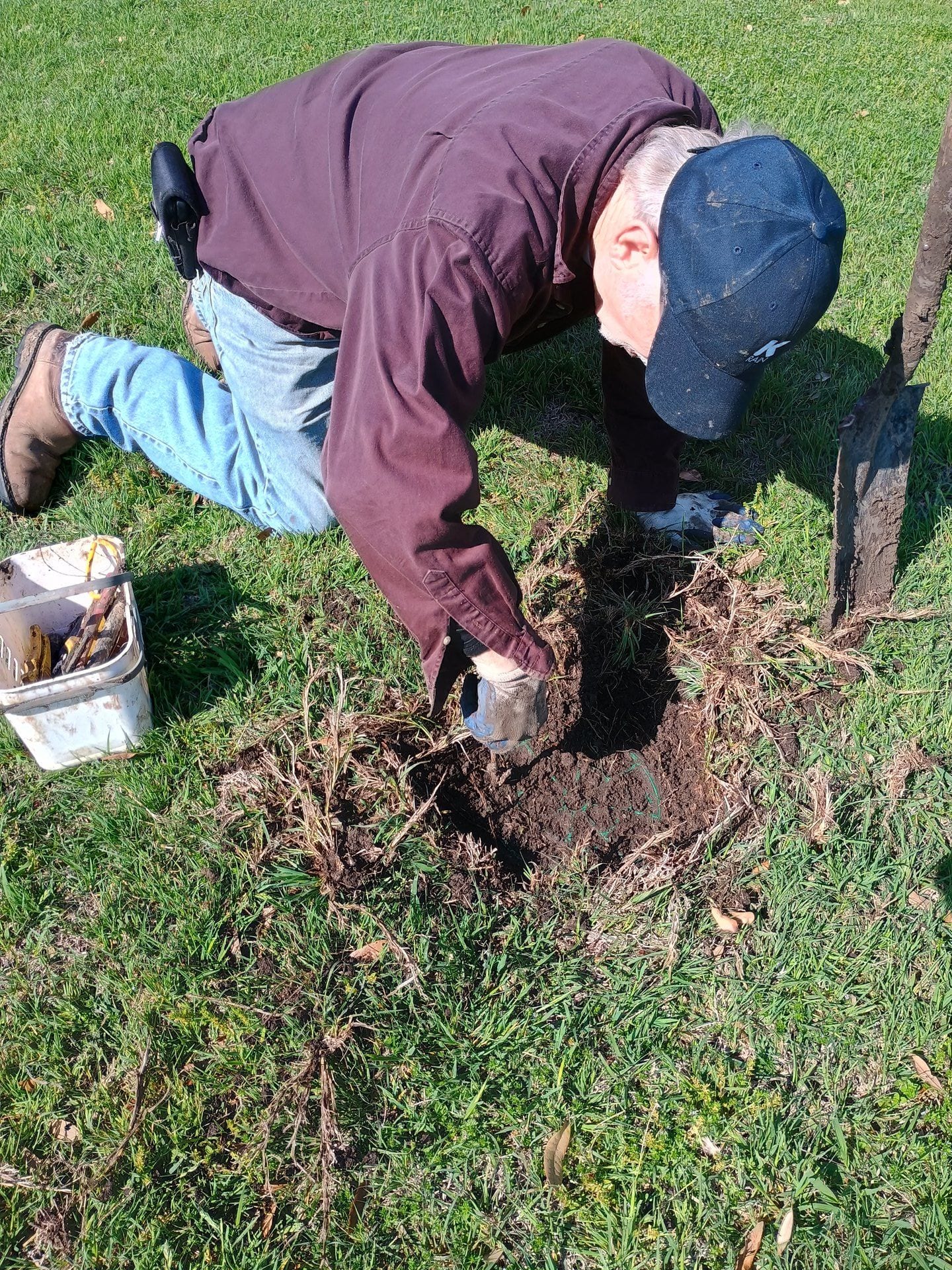 Irrigation technician using professional equipment to diagnose a buried valve