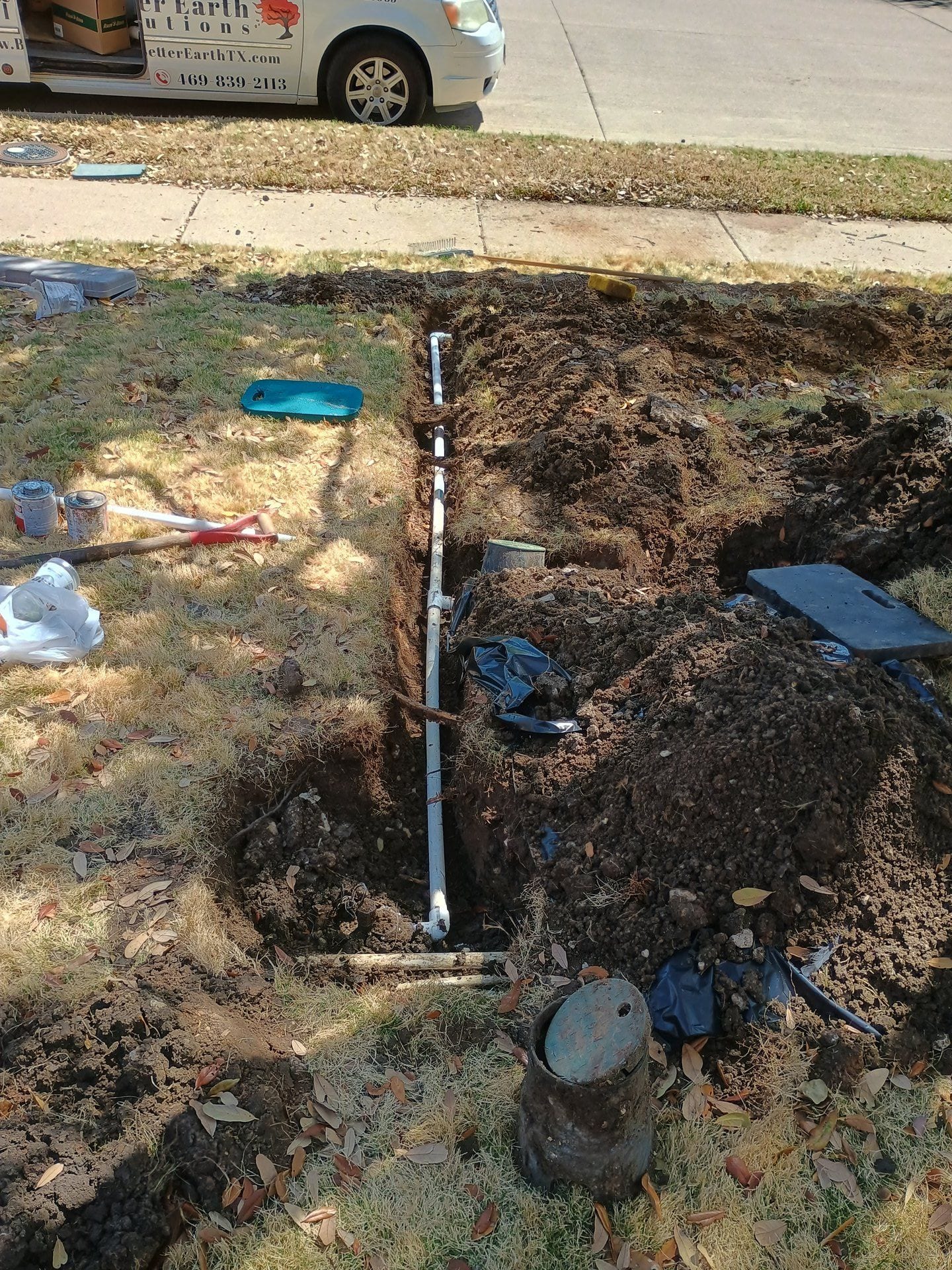 Technician repairing an irrigation valve that was engulfed by tree roots